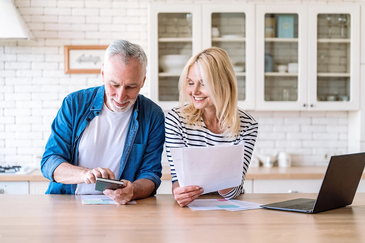 couple in kitchen on laptop